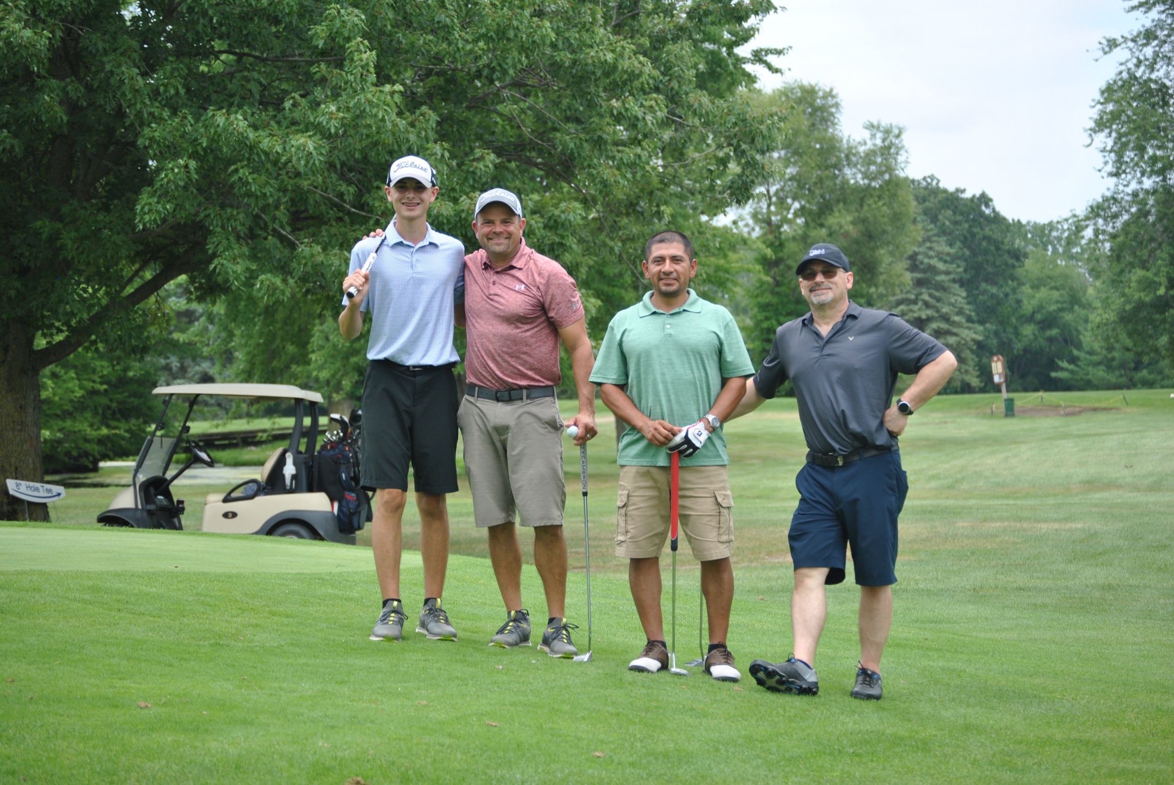 Four golfers standing on the course