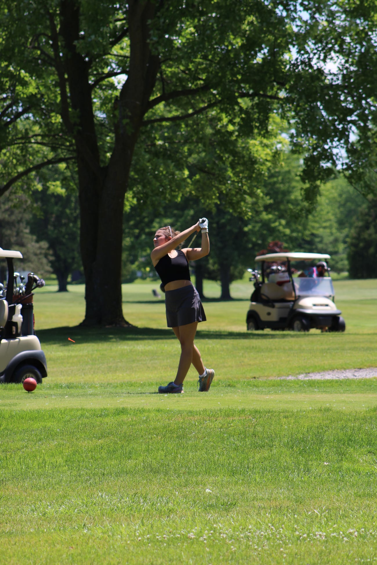Golfer following through on a shot during an outing